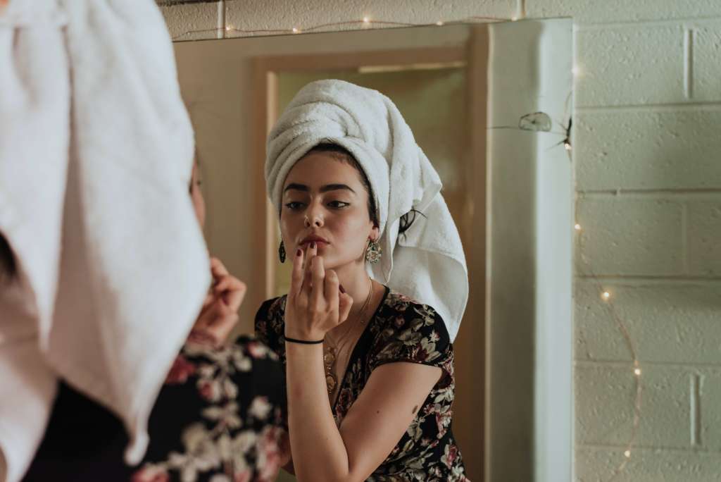 Woman practicing integrative dermatology with an at-home routine