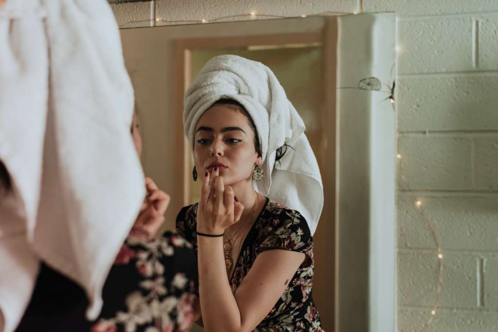 Woman practicing integrative dermatology with an at-home routine